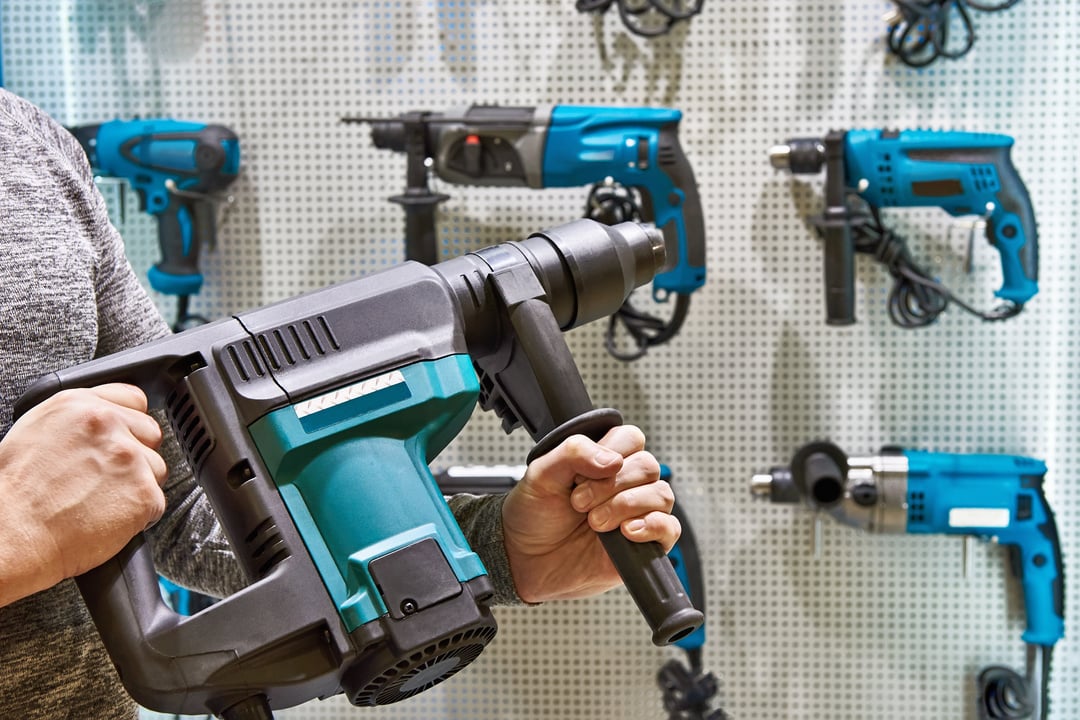 Hammer drill in man's hands